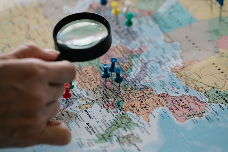 A visualization of a magnifying glass on a map pin, representing Local SEO's impact on modern business