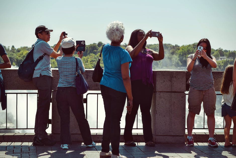 An image featuring diverse hands holding smartphones, representing the wide array of users generating content for the brand.