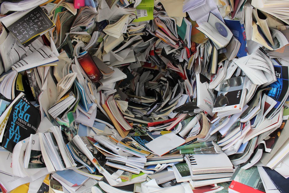 An image illustrating the challenges faced in proofreading, showing a person surrounded by piles of books, papers, and digital devices, representing the vast amount of content that needs to be managed and proofread in the digital era.