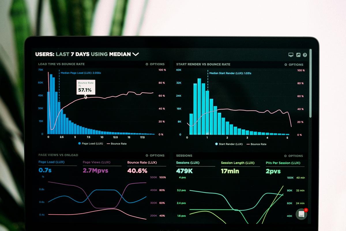 A digital marketing image showing a person using a laptop with charts and graphs displayed on the screen